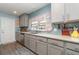 Kitchen featuring stainless appliances, grey cabinets and colorful window treatment at 2248 Bonn Ct, Punta Gorda, FL 33983