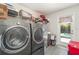 Laundry room featuring washer and dryer, with shelving and access to the backyard at 2248 Bonn Ct, Punta Gorda, FL 33983