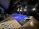 Evening view of a pool and spa illuminated with purple LED lighting at 2248 Bonn Ct, Punta Gorda, FL 33983