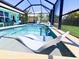 Inviting pool with sun shelf offers a refreshing escape in a private screened lanai at 2248 Bonn Ct, Punta Gorda, FL 33983
