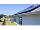 Close-up of solar panels on the roof and a modern exterior with a fenced in yard at 2248 Bonn Ct, Punta Gorda, FL 33983