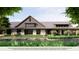 Community clubhouse featuring stone accents, covered entryway, and well-maintained landscaping at 2366 Wise River Lane, Zephyrhills, FL 33539