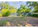 Grassy backyard surrounded by lush foliage and a chain-link fence at 4621 25Th S Ave, St Petersburg, FL 33711