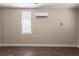 Bedroom featuring neutral walls, wood-look flooring, and a mini-split AC unit at 4621 25Th S Ave, St Petersburg, FL 33711