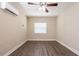 Bedroom with wood-look flooring, ceiling fan, and mini-split AC unit at 4621 25Th S Ave, St Petersburg, FL 33711