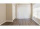 Bedroom featuring modern laminate flooring, closet, and bright window at 4621 25Th S Ave, St Petersburg, FL 33711