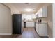 Bright kitchen with white cabinetry, granite countertops, stainless steel appliances, and modern flooring at 4621 25Th S Ave, St Petersburg, FL 33711