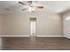 Living room with wood-look flooring, neutral paint, ceiling fan, and views into other rooms at 4621 25Th S Ave, St Petersburg, FL 33711