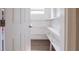 Bright, white pantry with built-in shelving and wood-look flooring at 4621 25Th S Ave, St Petersburg, FL 33711