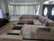 Inviting living room with a large sectional, stylish rug and ample natural light at 4666 Clarke St, North Port, FL 34286