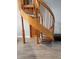 Unique spiral staircase with wood flooring and trim makes a great architectural feature at 4666 Clarke St, North Port, FL 34286