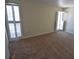 Bedroom featuring neutral carpet and bright shuttered windows at 4826 Marine Pkwy # 202, New Port Richey, FL 34652