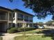 Well-maintained building exterior with manicured landscaping and covered parking at 4826 Marine Pkwy # 202, New Port Richey, FL 34652
