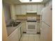 The kitchen features white appliances, cabinets, and countertops at 4826 Marine Pkwy # 202, New Port Richey, FL 34652