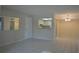 Open living room area with tiled floors that connects to the kitchen at 4826 Marine Pkwy # 202, New Port Richey, FL 34652