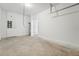 Spacious garage featuring concrete flooring, and white walls offering ample storage and utility space at 6155 Pina Colada St, Zephyrhills, FL 33542