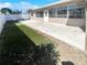Backyard with a concrete patio, a white fence, and newly installed artificial turf at 10454 138Th St, Largo, FL 33774