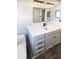 Renovated bathroom with shiplap accent wall, modern vanity with a white countertop, and sleek fixtures at 10454 138Th St, Largo, FL 33774