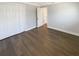 Neutral bedroom featuring wood-look flooring, double door closet, and freshly painted walls at 10454 138Th St, Largo, FL 33774