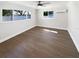 Bright bedroom with hardwood floors, new lighting fixture, and an abundance of natural light at 10454 138Th St, Largo, FL 33774