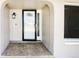 Covered front entrance offers tile flooring and a decorative glass front door at 10454 138Th St, Largo, FL 33774