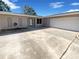 Exterior view of home featuring attached garage and ample driveway space at 10454 138Th St, Largo, FL 33774