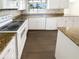 Kitchen with granite counters, white cabinets, and stainless appliances at 10454 138Th St, Largo, FL 33774