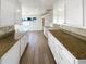 Bright kitchen features white cabinets and granite countertops at 10454 138Th St, Largo, FL 33774