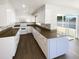 Bright kitchen with white cabinets, granite countertops, and luxury vinyl flooring at 10454 138Th St, Largo, FL 33774