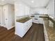 Kitchen featuring granite countertops, white cabinets, and stainless-steel appliances at 10454 138Th St, Largo, FL 33774