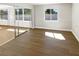 Open living room with sliding glass doors and wood-look flooring at 10454 138Th St, Largo, FL 33774