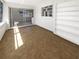 Bright living room showcasing sliding glass doors leading to another room and integrated shelving at 10454 138Th St, Largo, FL 33774