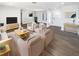 Staged living room with luxury vinyl flooring, stylish furniture, and a light and airy feel at 10454 138Th St, Largo, FL 33774