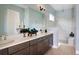 Modern bathroom with double vanity, tiled shower, and sleek fixtures at 2726 Wise River Lane, Zephyrhills, FL 33539