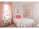 Charming bedroom with pink accents, a whimsical bunny print, and soft, natural lighting at 2726 Wise River Lane, Zephyrhills, FL 33539
