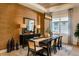 Formal dining room featuring a textured accent wall, modern lighting, and seating for six at 2726 Wise River Lane, Zephyrhills, FL 33539