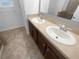 Bathroom vanity featuring double sinks and a framed mirror at 1311 Trailwater St, Ruskin, FL 33570
