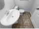 Clean half-bathroom featuring a pedestal sink and tile flooring at 1311 Trailwater St, Ruskin, FL 33570