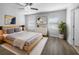 Bright and airy primary bedroom with neutral decor, hardwood floors and lots of natural light at 1311 Trailwater St, Ruskin, FL 33570