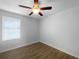 Bedroom with wood flooring, a ceiling fan, and a window with horizontal blinds at 1311 Trailwater St, Ruskin, FL 33570