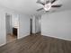 Spacious bedroom with wood floors, ceiling fan, and ensuite bathroom access at 1311 Trailwater St, Ruskin, FL 33570