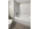 Bathroom features single sink vanity with wood cabinets, a mirror and tiled shower and tub at 30406 Arrochar St, Wesley Chapel, FL 33545