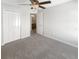 Bedroom with neutral carpet, a doorway, a closet and a ceiling fan at 30406 Arrochar St, Wesley Chapel, FL 33545