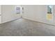 Bedroom with neutral carpet, three windows providing ample natural light, and outlets for convenience at 30406 Arrochar St, Wesley Chapel, FL 33545