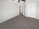 Neutral bedroom featuring a closet, a doorway, neutral carpet and a ceiling fan at 30406 Arrochar St, Wesley Chapel, FL 33545