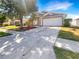 Charming single-story home featuring a well-manicured lawn, two-car garage, and inviting curb appeal at 30406 Arrochar St, Wesley Chapel, FL 33545