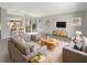 Bright living room with neutral decor, a view into the kitchen, and ample natural light at 30406 Arrochar St, Wesley Chapel, FL 33545