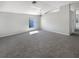 Spacious living room featuring neutral paint, carpet flooring and a bright window offering natural light at 30406 Arrochar St, Wesley Chapel, FL 33545
