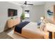 Modern bedroom features a large window, ceiling fan, and stylish furniture at 30406 Arrochar St, Wesley Chapel, FL 33545
