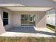 Covered patio featuring a concrete floor, neutral siding, and views of the backyard at 30406 Arrochar St, Wesley Chapel, FL 33545